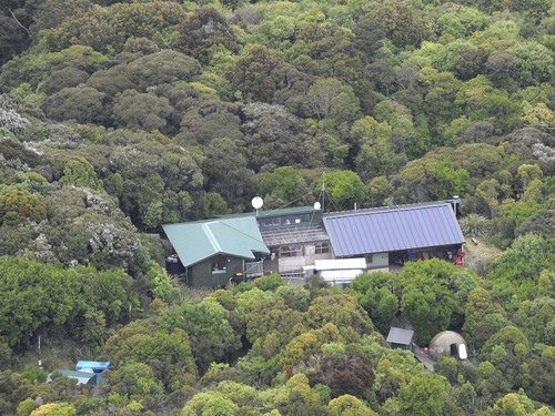 Codfish Island DOC hut from the air with solar panel electricity by Tansley Electrical