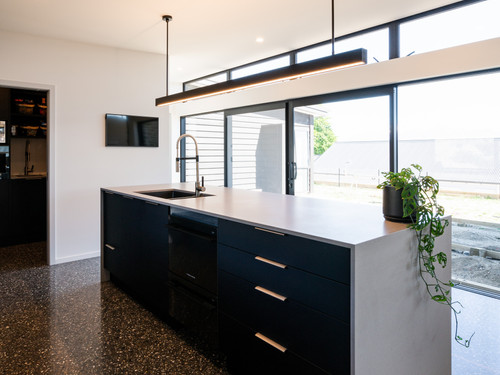 This black kitchen looks stunning with a polished concrete floor