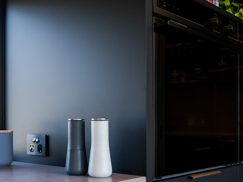 The black theme is carried through into the pantry and creates a dramatic space