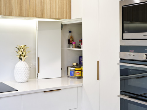 The junction of upper cabinets and pantry called for an innovative design