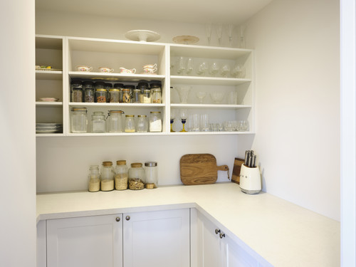 The adjoining pantry is light and bright, and offers superb storage.