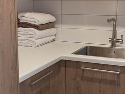 Laundry storage with sink and pull out wash basket areas