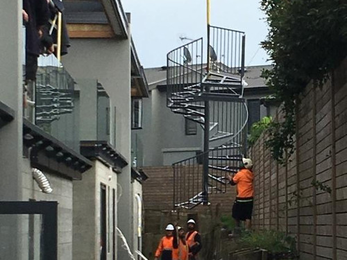 Spiral Staircase manufactured by Otago Engineering maneuvered into position with the help of a crane.