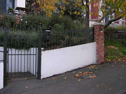 Concrete and wrought iron garden fence