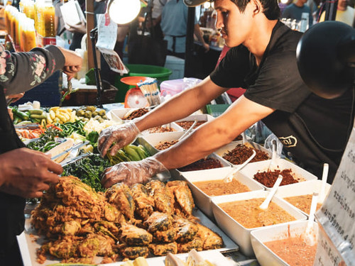 A vendor selling food at an authentic street market.