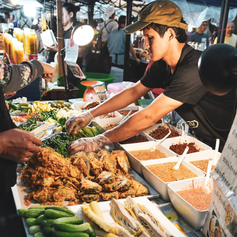 A vendor selling food at an authentic street market.