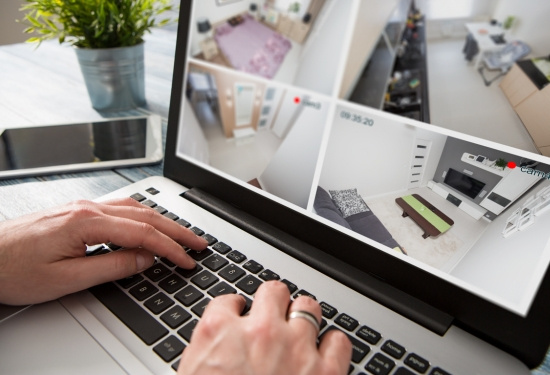 Aged care manager accessing CCTV footage on laptop.