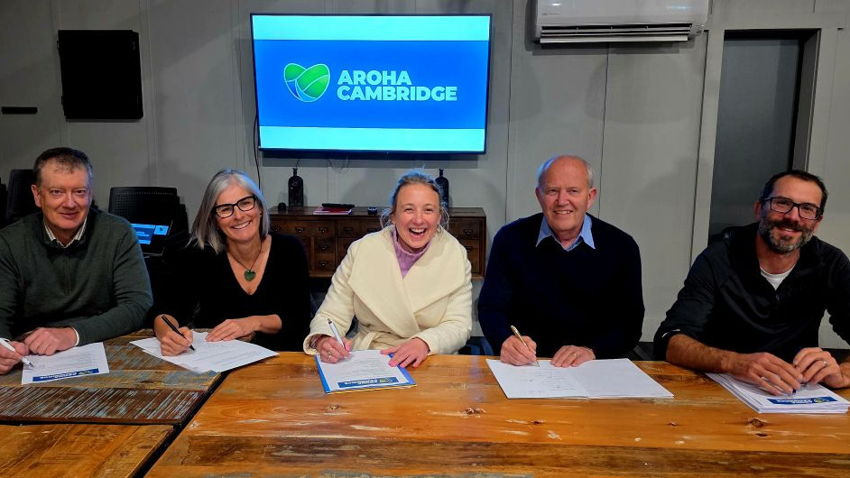 The five trustees of the Aroha Cambridge Trust Board signing the Trust Deed