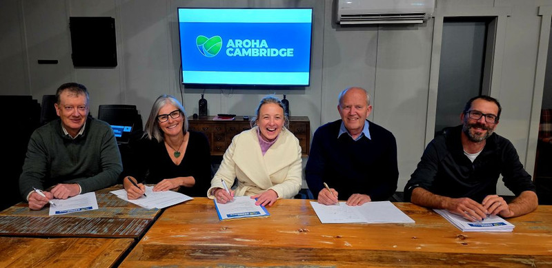 The five trustees of the Aroha Cambridge Trust Board signing the Trust Deed