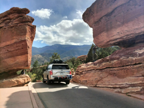Truck driving between rocks on road in Garden of the Gods