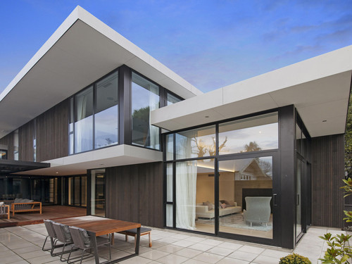 This Christchurch home features flat roofs and swooping soffits.