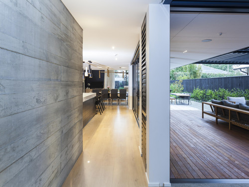 the use of textured concrete tilt panels on the interior and exterior of the house is a noticeable feature
