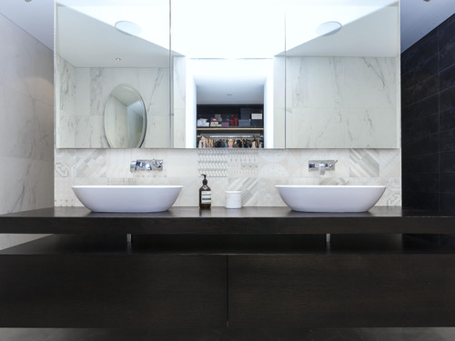 The master bathroom featuring his and hers vanities