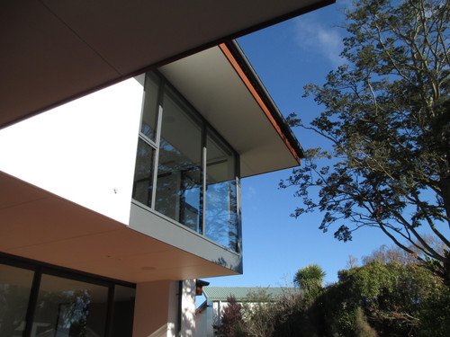Large windows with overhanging soffits contrasting with hand-crafted cedar fascia.