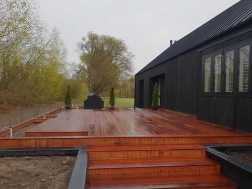 A raised decking with boxed in gardens 