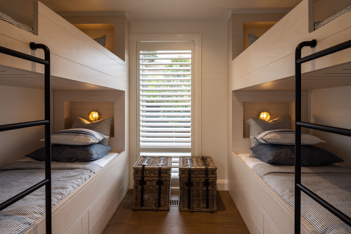 Ship cabin is the inspiration behind the bunk room. Use of port hole designed lights enhances the coastal theme.