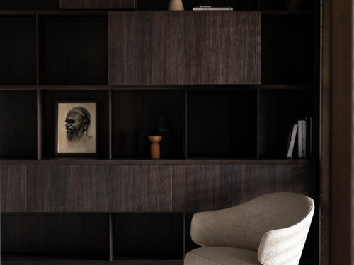 An intimate sitting area features beautiful dark cabinetry