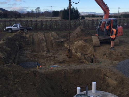 A septic tank being installed with an excavator