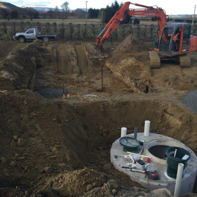 A digger helping with the installation of a septic tank
