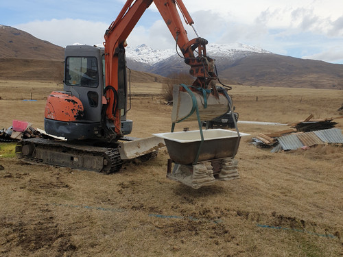 Relocating the old wood fired bathtub to its new outdoor location